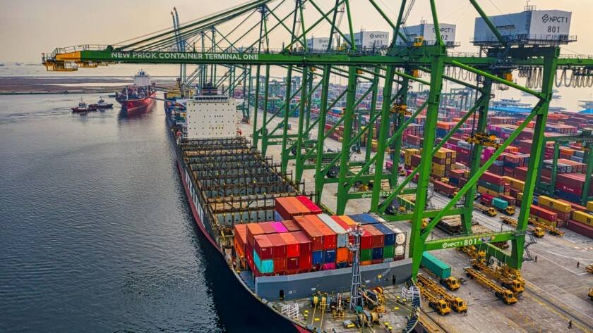 Aerial view of a cargo ship docked at Container Terminal, showcasing vibrant logistics activity.